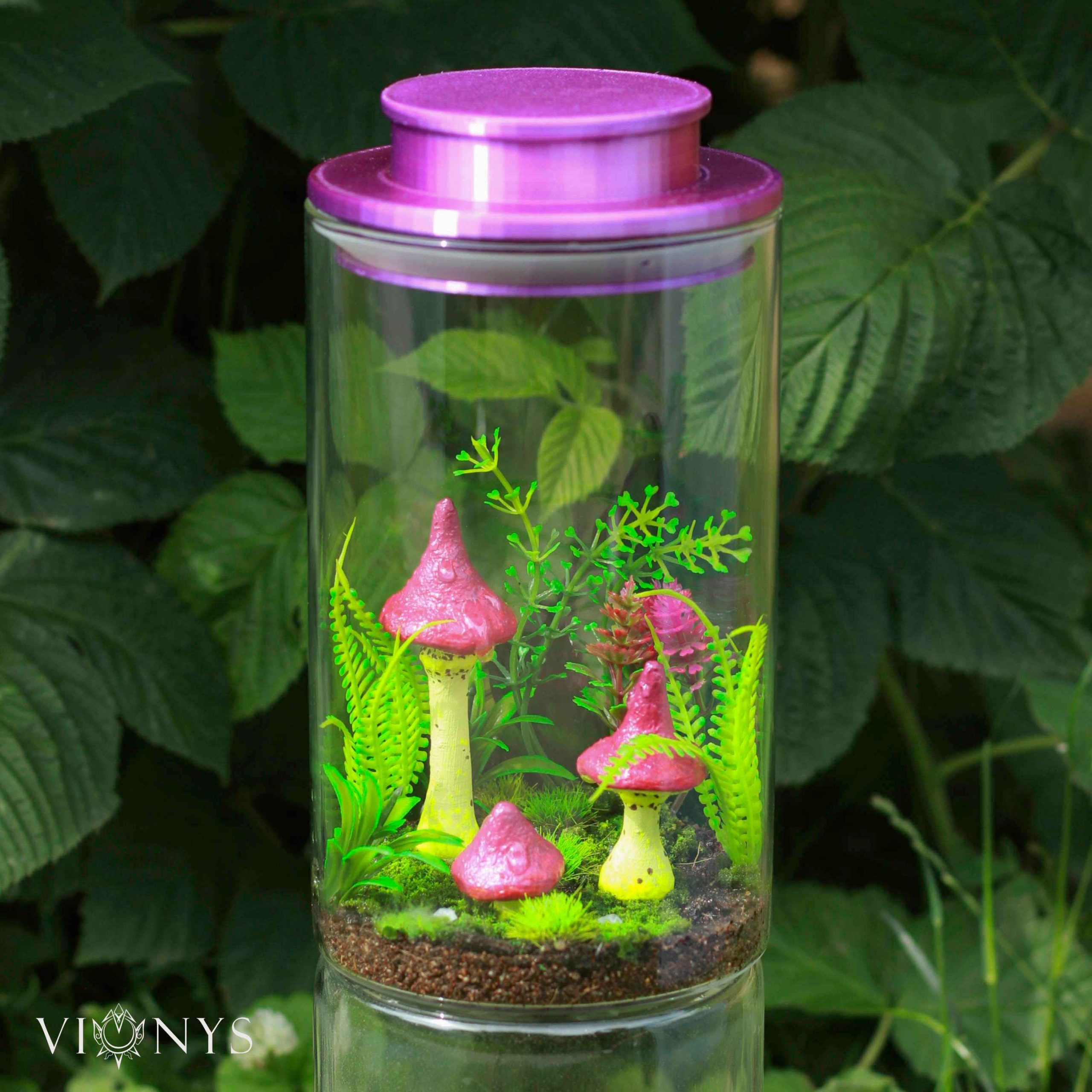 Fantasy LED lamp with 3D printed yellow and pink mushrooms and vegetation inside.