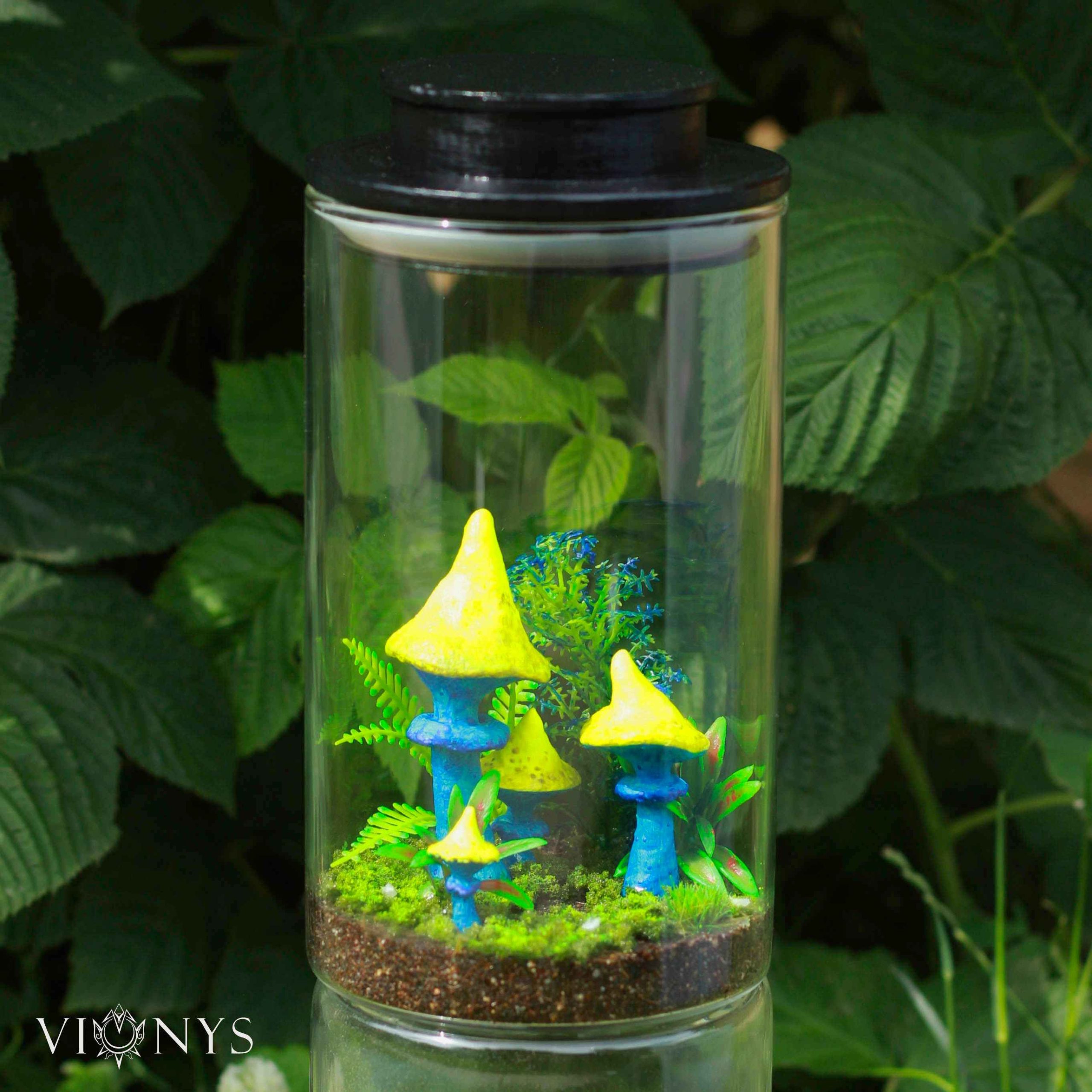 Fantasy LED lamp with 3D printed yellow and blue mushrooms and vegetation inside.